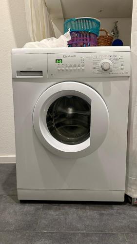 a white washing machine sitting in a room at Auszeit im Heinental in Wildberg