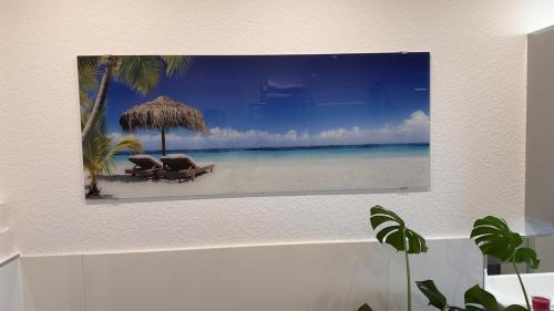 a picture of a beach with chairs and an umbrella at Auszeit im Heinental in Wildberg