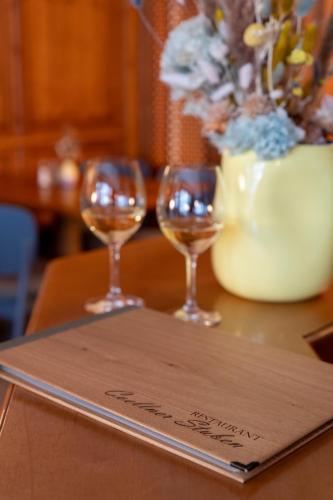 three wine glasses sitting on top of a table at Hotel Coellner Hof in Cologne