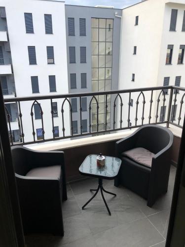 a balcony with two chairs and a table at Sweet Escape in Bar