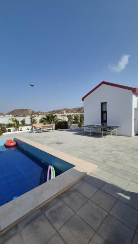 a swimming pool on the roof of a house at مزرعة-جوري--Jory-Farmhouse in Hatta