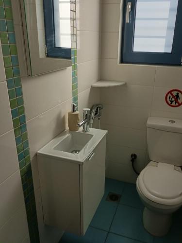 a bathroom with a sink and a toilet at Dimitris House in Karistos