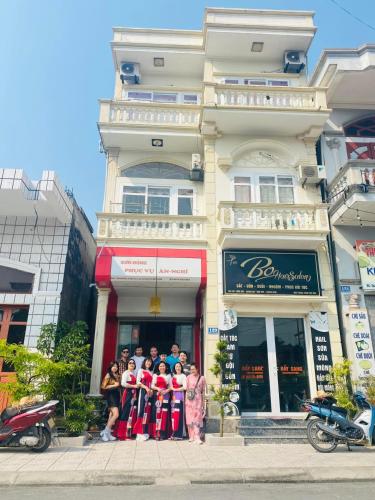 a group of people standing in front of a building at Sơn Đông Hotel in Quan Lạn