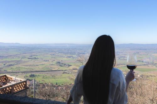 a woman holding up a glass of wine at Cortona Skyline Retreat in Cortona