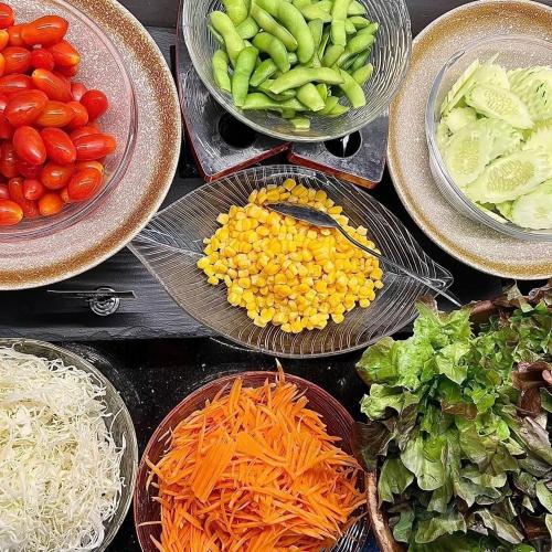 a group of bowls of vegetables on a table at 12 The Residence Hotel at Don Mueang Airport in Bangkok