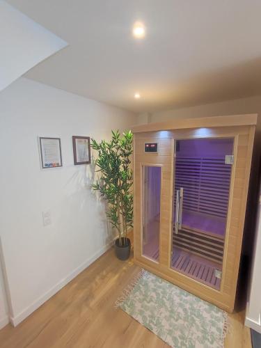 a room with a shower with a plant in it at Maison avec Sauna - 1 chambre - 2 à 4 personnes in Volvic