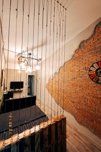 a chandelier in front of a brick wall at Little Ryukyu Hermit Crab Homestay in Xiaoliuqiu