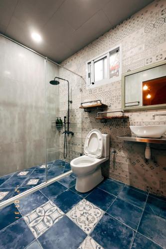 a bathroom with a shower and a toilet and a sink at Little Ryukyu Hermit Crab Homestay in Xiaoliuqiu