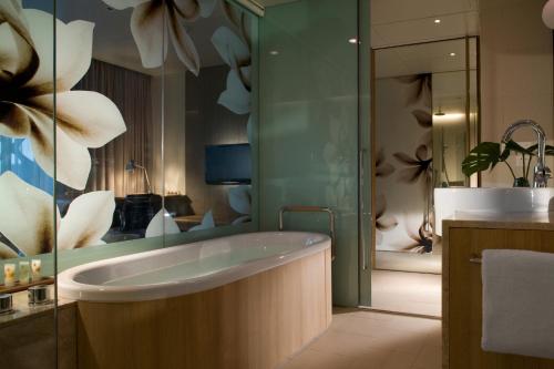 a bathroom with a bath tub and a sink at Crowne Plaza Changi Airport by IHG in Singapore