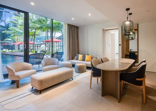 a living room with a table and chairs at Crowne Plaza Changi Airport by IHG in Singapore