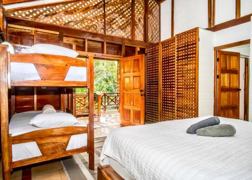 a bedroom with two bunk beds in a house at All Private Villa, Pool, HOT Jacuzzi, Magic Jungle Garden, Cocles Beach in Cocles