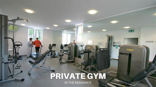 a gym with several treadmills and people in the background at Casa Luce with Private Gym and Netflix - Lugano in Viganello