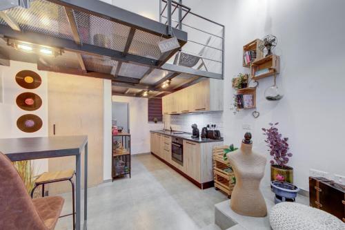 a room with a kitchen with a table and a counter at Unique studio loft, walking distance to Valletta in Hamrun