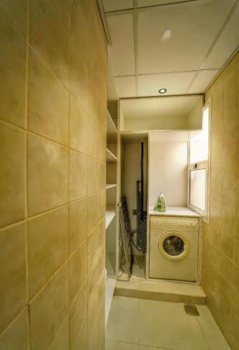 a laundry room with a washing machine in a room at Asfar Resorts Al Ain in Al Ain