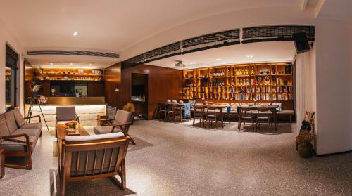 a room with a library with tables and chairs at Without Asking East or West in Zhoushan
