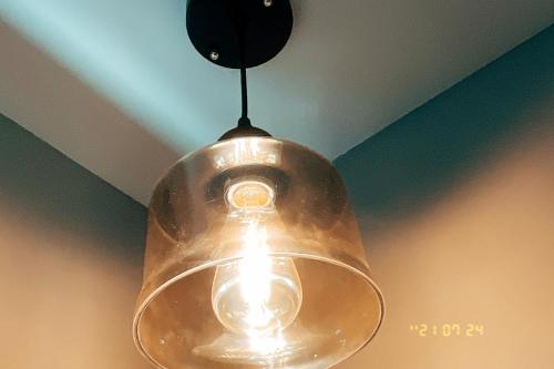 a glass pendant light hanging from a ceiling at Little Ryukyu Hermit Crab Homestay in Xiaoliuqiu