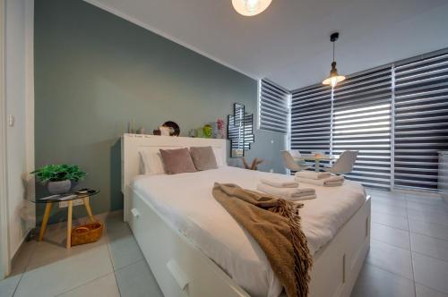 HamrunにあるCosy Penthouse in Hamrun - Walking distance to Vallettaの大きな白いベッドとテーブルのある寝室