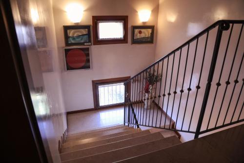 a staircase in a house with some pictures on the wall at Hotel Villa Sara in Mestre