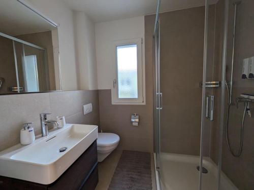 a bathroom with a sink and a toilet and a shower at UP&GREAT Apartments - Chic Urban Homes in Zürich