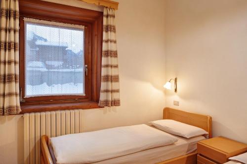 A bed or beds in a room at Baita Franz 2 Livigno