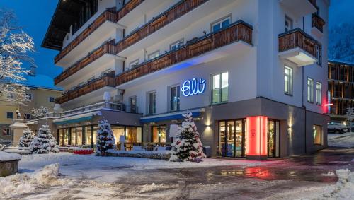 a building with a sign on it in the snow at Hotel Blü Gastein in Bad Hofgastein