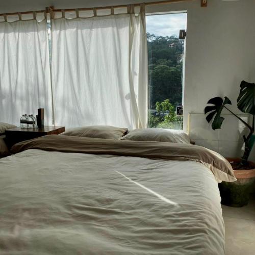 a bedroom with a large bed with a window at Nằm Mơ 3 Homestay - chi nhánh Đặng Thái Thân in Da Lat