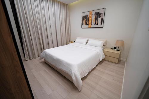 a bedroom with a white bed and a window at Latifa Housing in Riyadh