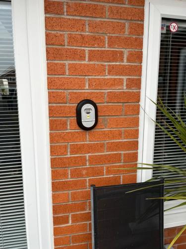 a brick wall with a soap dispenser on it at Happy days Moreton , 2 miles from Hoylake Wirral in Moreton