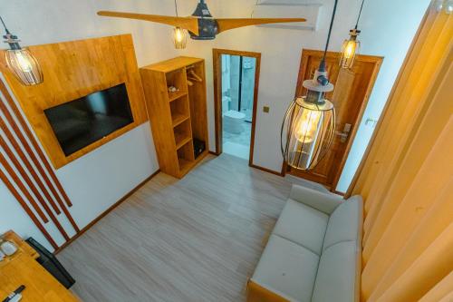 an overhead view of a living room with a couch and a television at Sunny Stay Dhigurah in Dhigurah