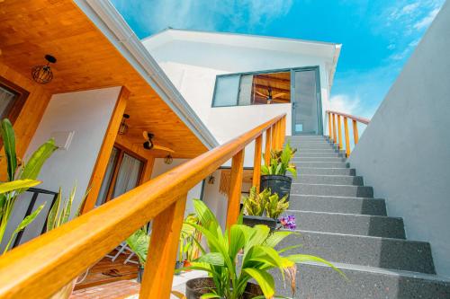 a staircase leading up to a house with plants at Sunny Stay Dhigurah in Dhigurah