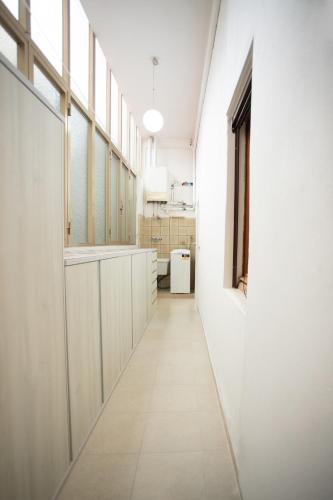 a corridor of a room with white walls and a long hallway at Dimora Alba di Mare in Pellestrina