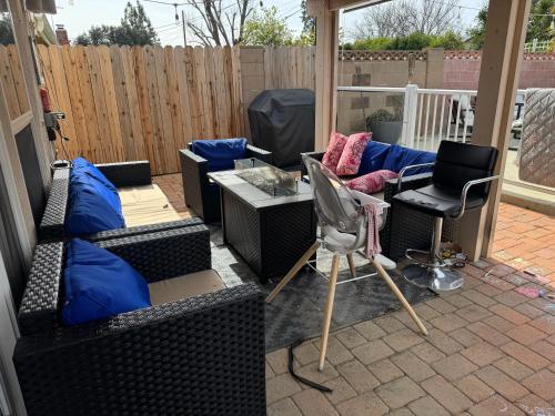 a patio with couches and a table and chairs at Casa Mia in Hidden Hills