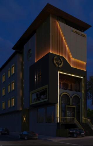 a hotel building with a car parked in front of it at Ringus Luxury Line in Mughal Sarāi