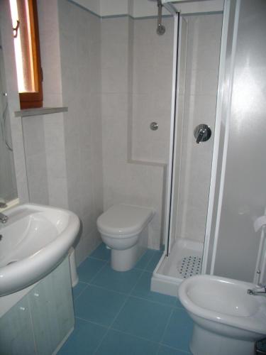 a bathroom with a sink and a toilet and a shower at Villetta Elena Via Loreto 64 villa 14 in Marcelli