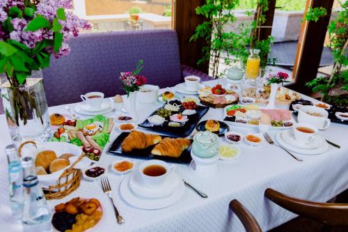 a table with a white table cloth with food on it at Historical Boutique Hotel in Baku