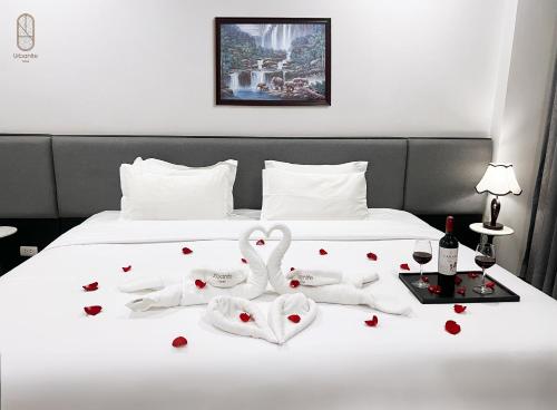 a bed with two swans made out of hearts at Urbanite Hotel in Vientiane