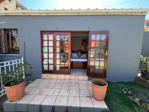 a porch of a house with doors and plants at Zensa Hotel & Spa in East London