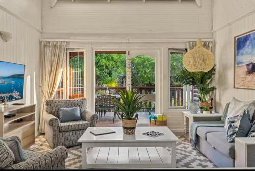 a living room with a couch and a table at Knysna Lagoon - Summer Breeze in Knysna