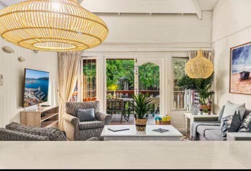 a large living room with a large chandelier at Knysna Lagoon - Summer Breeze in Knysna
