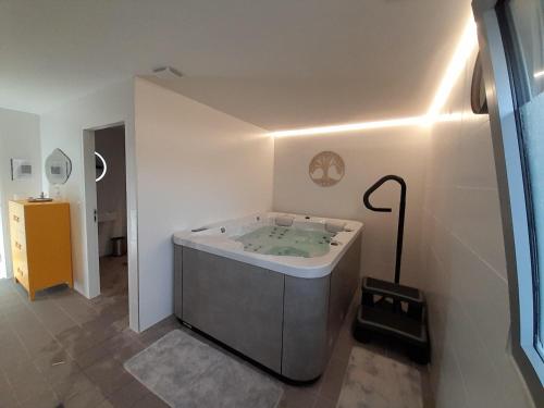 a bathroom with a bath tub in a room at The Originals City, Ara Hôtel, Landerneau in Landerneau