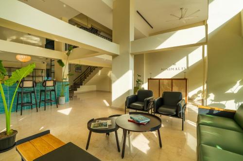 a living room with chairs and a table at Minimalist Panjim in Panaji