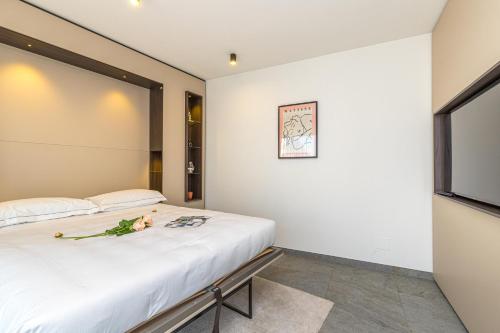a bedroom with a bed and a large window at ICON H Lugano - Luxury Suites & Apartments in Lugano