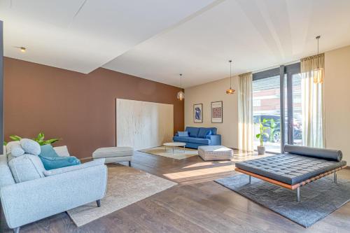 a living room with blue chairs and a couch at ICON H Lugano - Luxury Suites & Apartments in Lugano