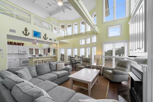 a large living room with a couch and a table at Calypso Breeze in Gulf Shores
