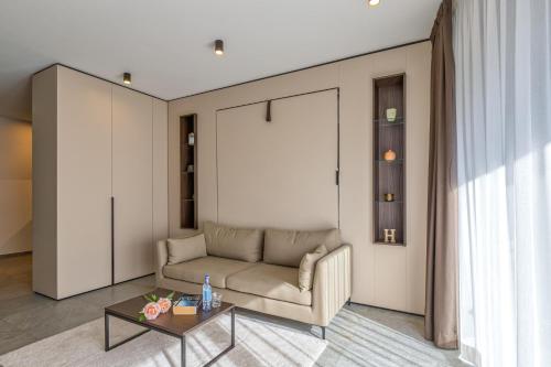 a living room with a couch and a table at ICON H Lugano - Luxury Suites & Apartments in Lugano