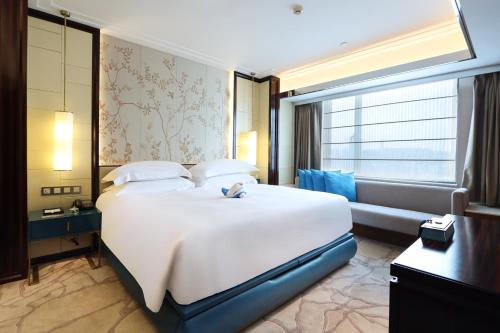 Ένα ή περισσότερα κρεβάτια σε δωμάτιο στο Xiamen Airlines Lakeside Hotel
