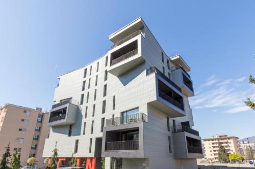 a tall white building with balconies at ICON H Lugano - Luxury Suites & Apartments in Lugano
