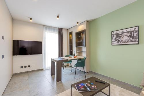 a living room with a table and a dining room at ICON H Lugano - Luxury Suites & Apartments in Lugano