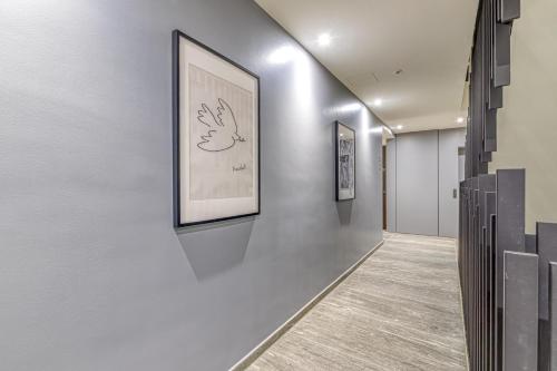 a hallway with two framed pictures on the wall at ICON H Lugano - Luxury Suites & Apartments in Lugano