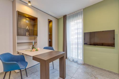 a dining room with a table and blue chairs at ICON H Lugano - Luxury Suites & Apartments in Lugano